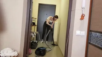 Vacuuming and mopping floor in rubber gloves