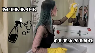 Cleaning the mirror in yellow rubber gloves