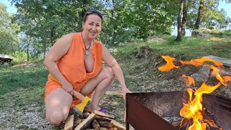 Wood cutting Mila. cooking on an open fire. Mila's Naturist Cooking. Mila naturist.