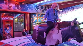 Mechanical bull riding,/ mum on the bull in Benidorm