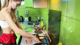 Girl cooking asparagus in short skirt #3