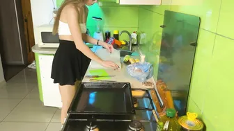 Girl cooking baked chicken in short skirt and transparent top #2