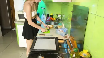 Girl cooking baked chicken in short skirt and transparent top #3