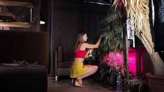 Girl in short skirt cleaning houseplant #3